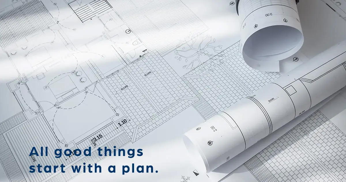 Architectural blueprint plans laid out with rolled construction drawings and the text.